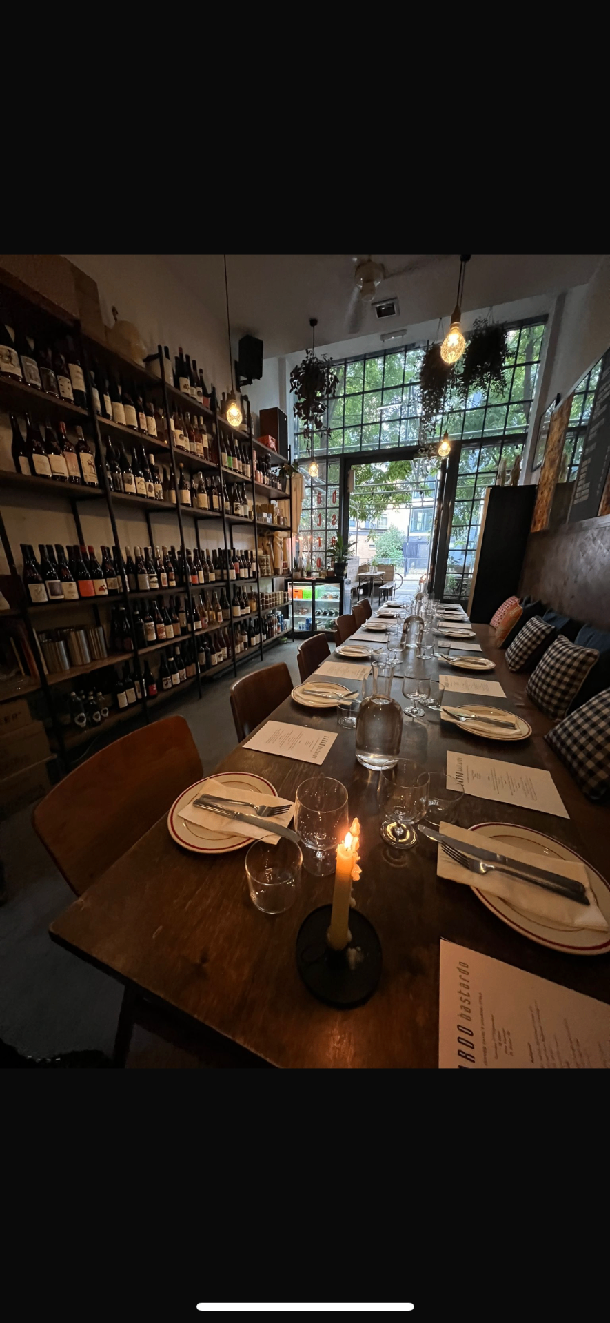 Hands raising glasses in a toast at a candlelit dinner